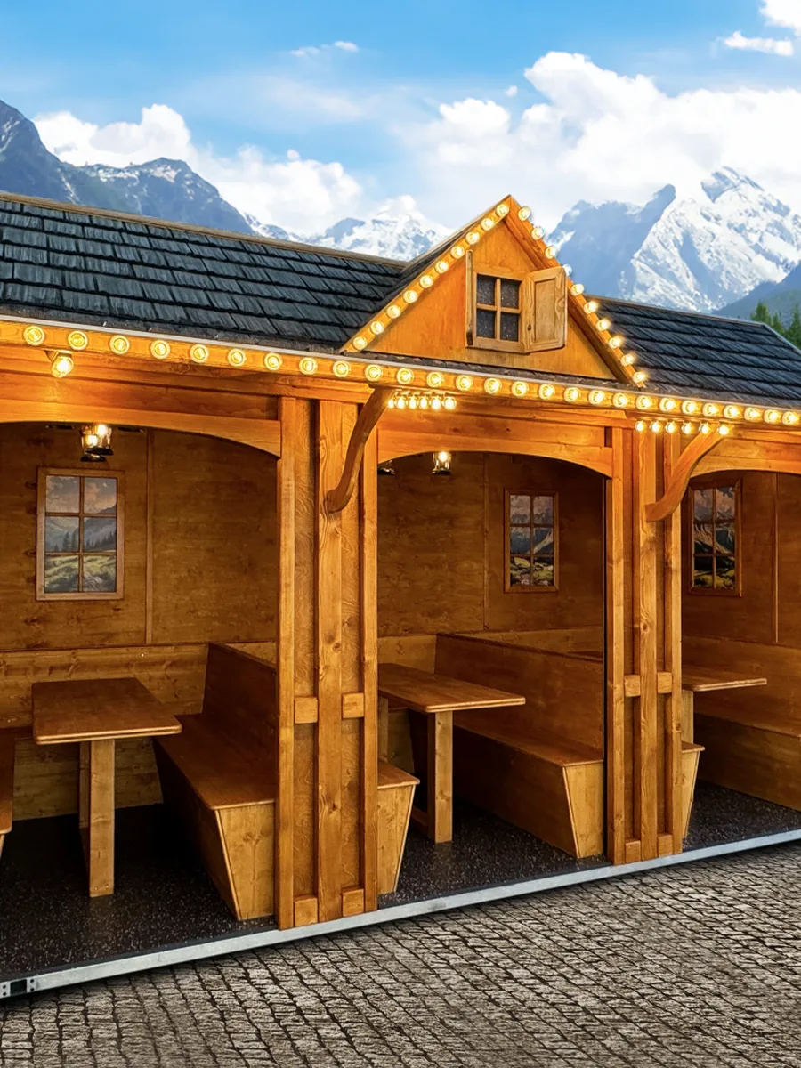 Sitzhütte mit offenen Durchgängen, Tischen und Bänken bei Tageslicht